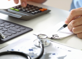 Doctor calculating costs