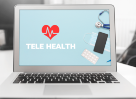 laptop with telehealth written on the screen 