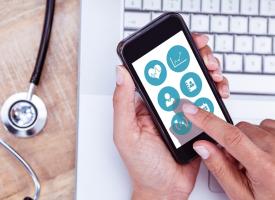 Stethoscope and person using mobile phone