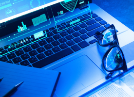 Image of keyboard with glasses on top and the word data highlighted 