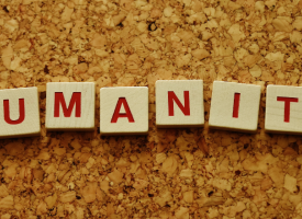 the word humanity written on blocks in red ink 