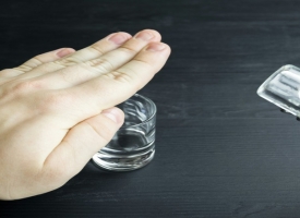Hand saying no to alcohol