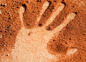 Hand print in sand