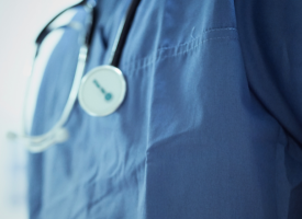 Close up of a stethoscope around a doctor's shoulders