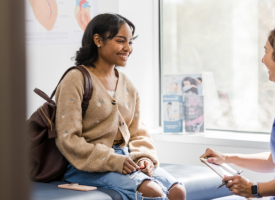 Female doctor and patient in treatment room 