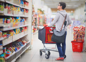 Woman shopping in supermarket aisle