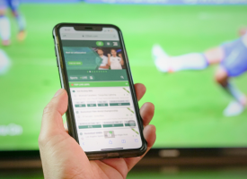 picture of someone betting on their phone 