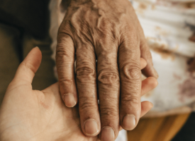 Older hand on top of younger hand