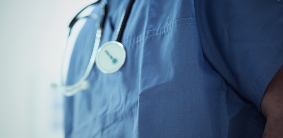 Close up of a stethoscope around a doctor's shoulders